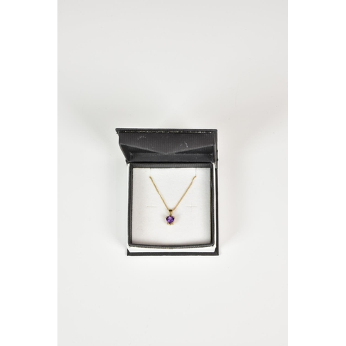 932 - A 9ct gold and heart shaped amethyst pendant, on an 18in. 9ct gold trace chain.