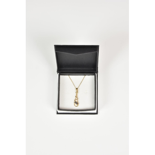 933 - A 9ct gold and sapphire pendant, on an 18in. curb link chain.