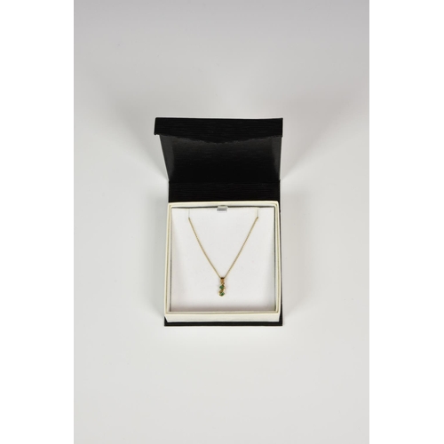 934 - A 9ct gold and two emerald drop pendant, on a 16in. 9ct gold chain.