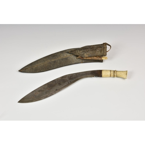 957 - A bone handled Kukri knife, in leather scabbard with karda/ chakmak etc.