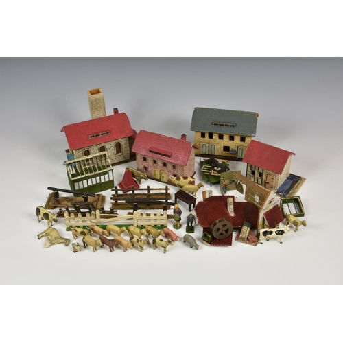 964 - A German Erzgebirge painted wooden town, comprising three houses (one partially dismantled), a water... 
