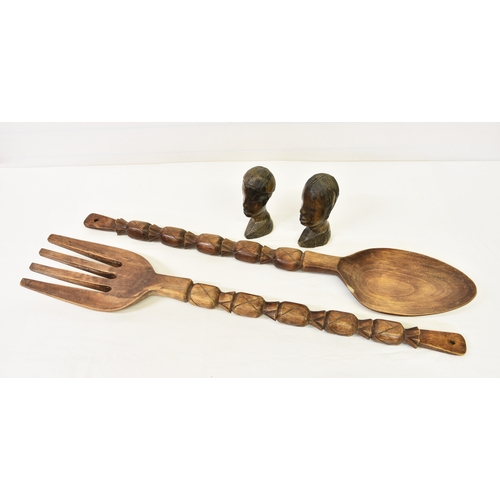 954 - Large African carved wooden spoon and fork, measuring 40 3/8in. (102.5cm.) long, together with a pai... 