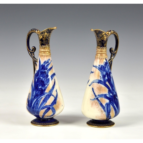 123 - A pair of Royal Doulton Burslem ewer vases, decorated with blue reeds on white ground with gold spra... 