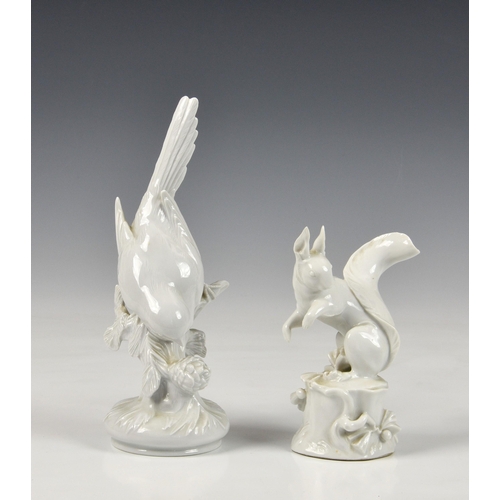 131 - Two white glazed Meissen bird and squirrel figures, modern, the bird, underglaze blue crossed sword ... 