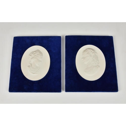 132 - A pair of Parian ware portrait plaques, depicting young maidens, mounted in rectangular blue velvet ... 