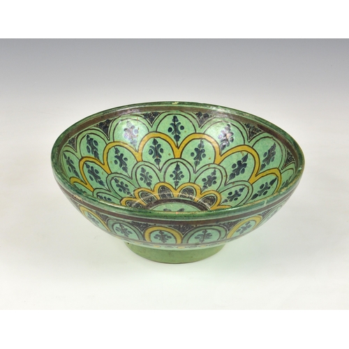 136 - An Iznik pottery bowl, probably 19th century, green and yellow tones having flowerhead symmetrical d... 