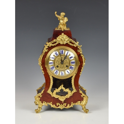 219 - A 19th century tortoiseshell and gilt metal mantel clock, with French style Roman enamel numerals, g... 