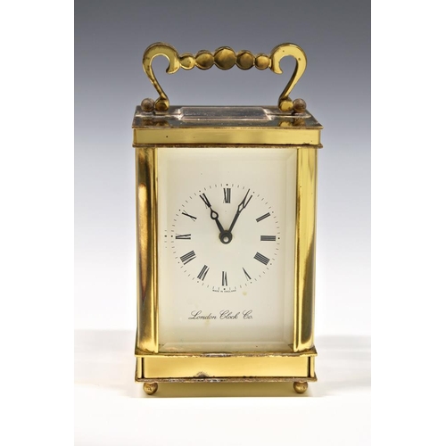 238 - A modern single train brass carriage clock by the London Clock Co., lacquer a/f, with key, winds and... 