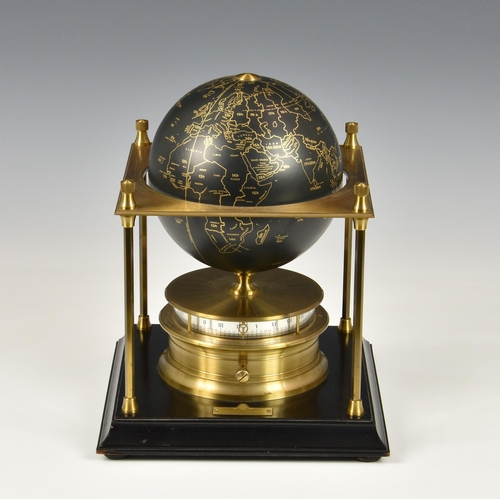 257 - The Royal Geographical Society World Clock,  1980, the black and gilt terrestial globe above a horiz... 