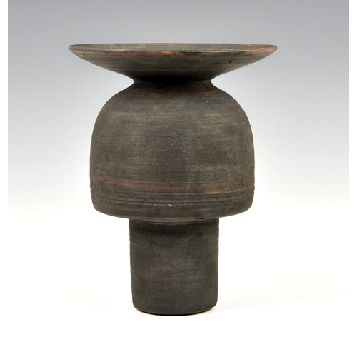 27 - A stoneware studio pottery vase in the manner of Hans Coper, 1970s, with disc rim over an inverted c... 