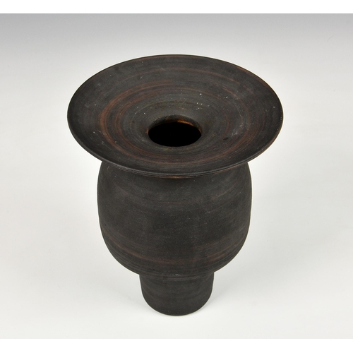 27 - A stoneware studio pottery vase in the manner of Hans Coper, 1970s, with disc rim over an inverted c... 