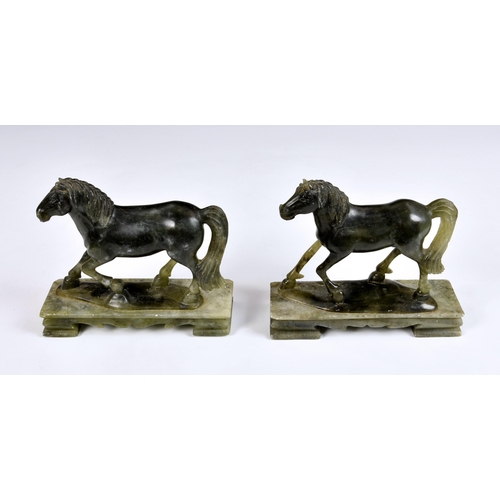 2865 - A near pair of carved green soapstone horses, 20th century, raised on rectangular plinths, 6 ½in. (1... 