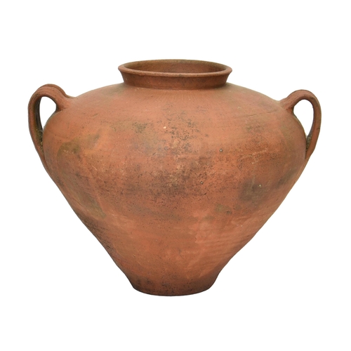 2868 - A twin handled terracotta oil jar or water vessel, of bulbous amphora form, having wide shoulders an... 