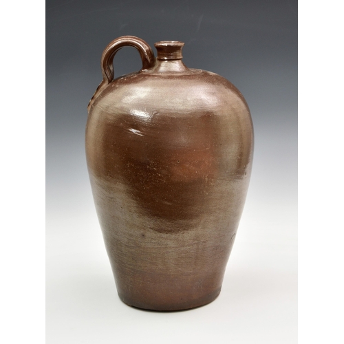 2869 - A stoneware salt glazed wine flagon, probably 19th century, of typical form with high loop handle, i... 