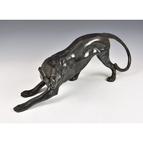 2878 - A contemporary hollow cast bronze sculpture of a crouching leopard, 26in. (66cm.) long, 9 ¾in. (24.9... 