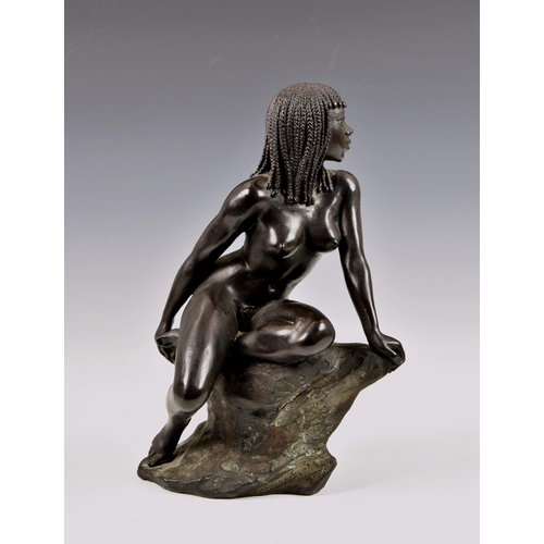 2889 - Ronald Cameron (British,1930-2013), A bronze figure of a nude Nubian female on rocky outcrop, signed... 