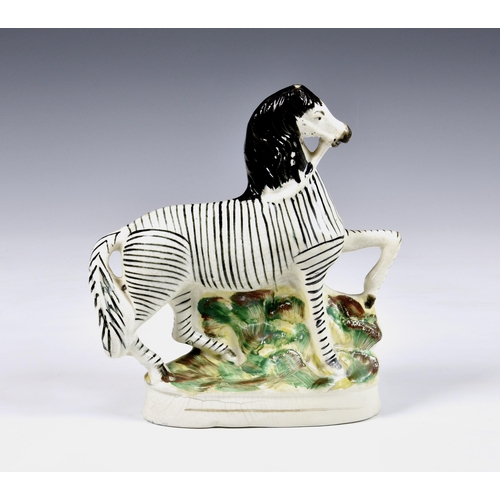 5 - A 19th century Staffordshire pottery flatback Zebra, 8 ¾in. (22.25cm.) high. * Glaze cracks and craz... 