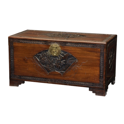 716 - A carved and part-ebonised camphorwood chest, 1930s, the lid, front and sides with fan shaped reserv... 