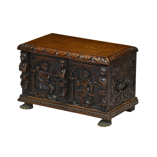 812 - A Victorian carved oak miniature cassone, the hinged top with foliate carved border over blind fret ... 