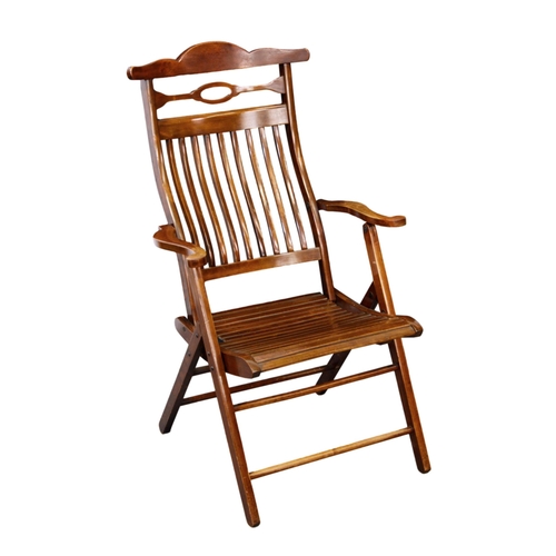 843 - A folding beech wood garden or deck chair, 1920s, the slatted back with yoke top rail, over a slatte... 