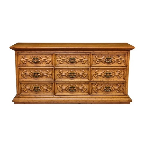 860 - A Continental honey oak low, nine drawer chest, in the 18th century style, the moulded top over thre... 