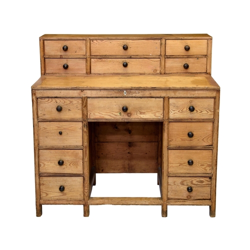 878 - A Victorian waxed pine artist's desk, the raised, six drawer back over a hinged top revealing storag... 