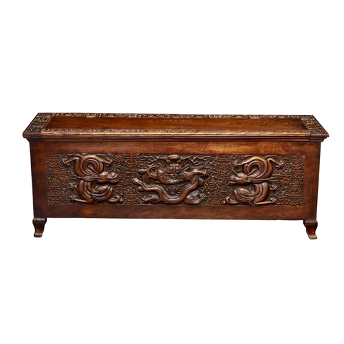 881 - A Chinese carved teak dragon chest, early 20th century, the hinged, panelled top with a carved borde... 