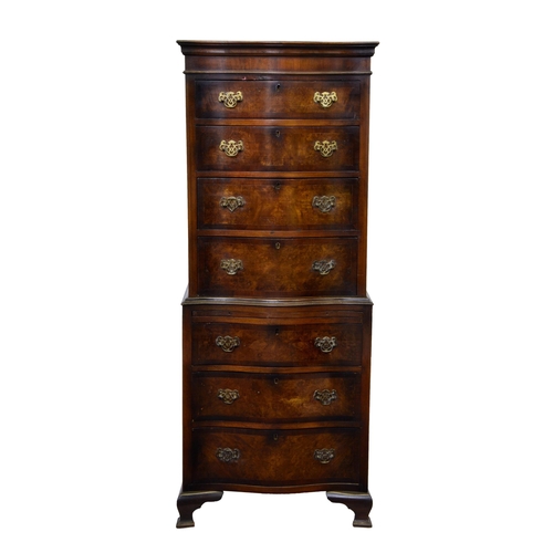 893 - A Georgian style cross banded burr walnut serpentine tallboy chest, 1930s, the moulded cornice over ... 