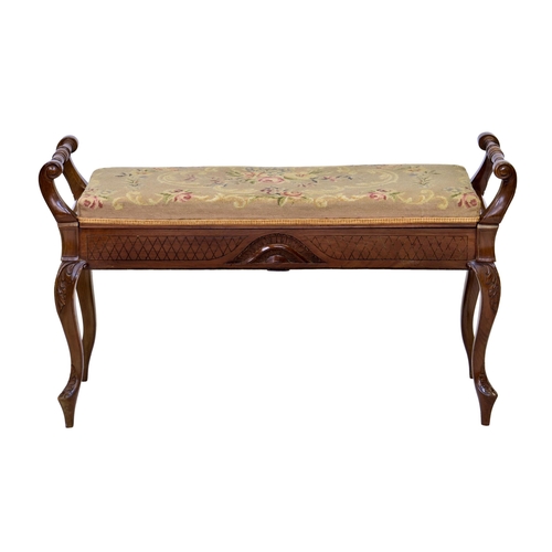 988 - An Edwardian walnut duet stool, with hinged floral needlework seat flanked by turned handles, over a... 