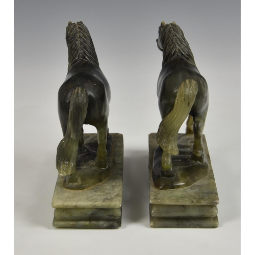 2865 - A near pair of carved green soapstone horses, 20th century, raised on rectangular plinths, 6 ½in. (1... 