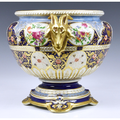 40 - A Victorian ceramic jardinière, of shaped pedestal form, having twin goat head handles and floral de... 