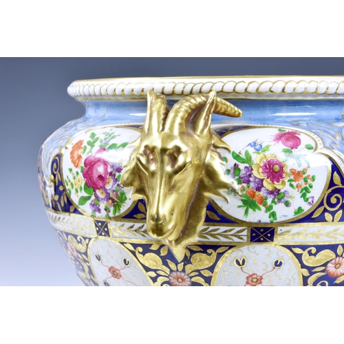 40 - A Victorian ceramic jardinière, of shaped pedestal form, having twin goat head handles and floral de... 