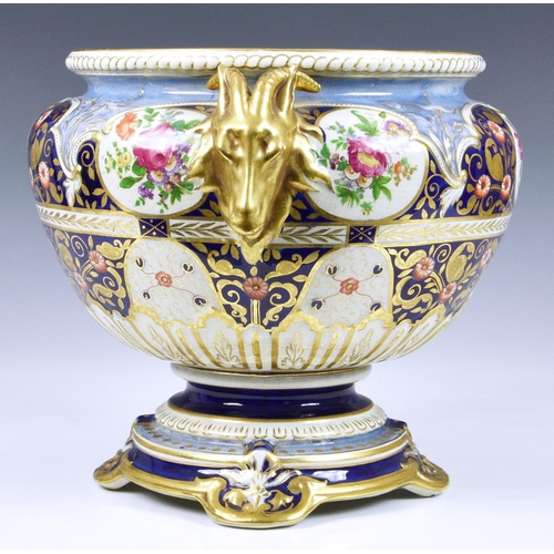 40 - A Victorian ceramic jardinière, of shaped pedestal form, having twin goat head handles and floral de... 