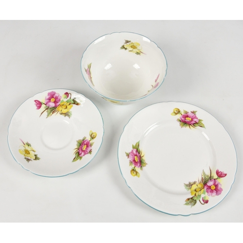 45 - A partial set of eleven Shelley Begonia pattern trios, each trio comprising a tea cup, saucer and pl... 