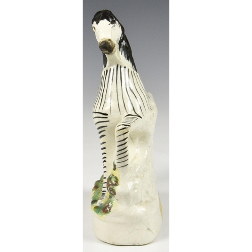 5 - A 19th century Staffordshire pottery flatback Zebra, 8 ¾in. (22.25cm.) high. * Glaze cracks and craz... 