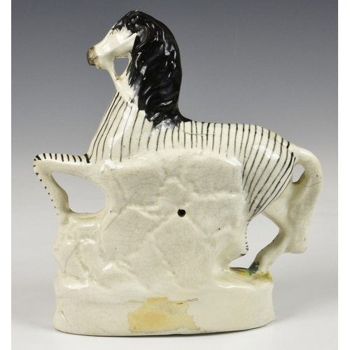 5 - A 19th century Staffordshire pottery flatback Zebra, 8 ¾in. (22.25cm.) high. * Glaze cracks and craz... 