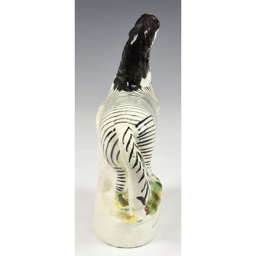 5 - A 19th century Staffordshire pottery flatback Zebra, 8 ¾in. (22.25cm.) high. * Glaze cracks and craz... 