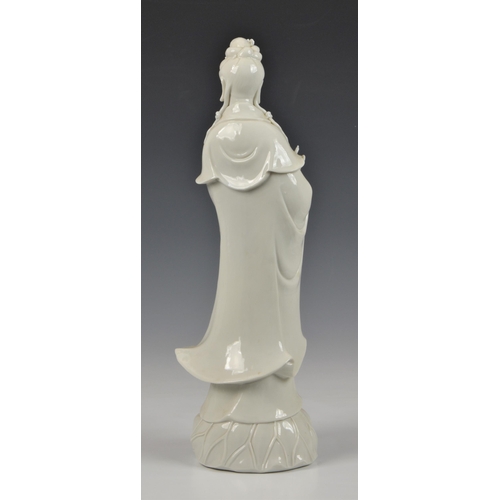 68 - A Blanc de Chine figure of Guanyin, Continental, 20th century, figure holding a vase, standing on lo... 