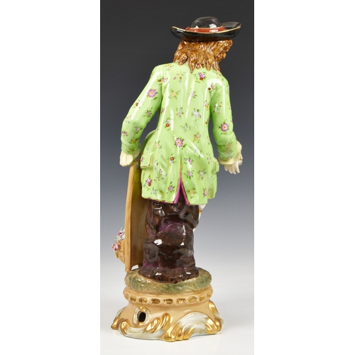 80 - An oversized Meissen porcelain style Dandy figurine, the Dandy sitting apon a tree trunk, wearing fl... 