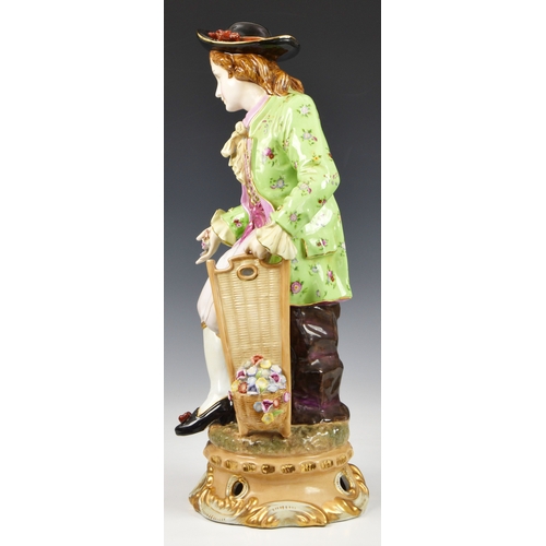 80 - An oversized Meissen porcelain style Dandy figurine, the Dandy sitting apon a tree trunk, wearing fl... 