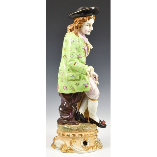 80 - An oversized Meissen porcelain style Dandy figurine, the Dandy sitting apon a tree trunk, wearing fl... 