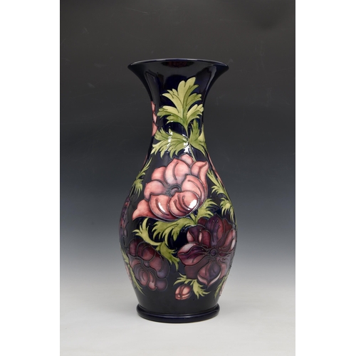 10 - A large Moorcroft Pottery floor standing baluster vase, with flared rim, 'anemone' pattern, on blue/... 