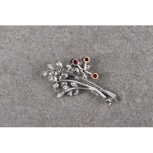 1027 - An 18ct two colour gold, ruby and diamond floral spray brooch, with five round cut rubies in yellow ... 