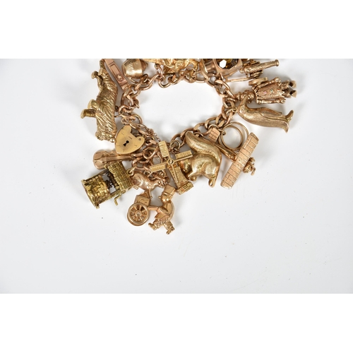 1060 - A 9ct gold charm bracelet, having seventeen charms, to include elephant, squirrel, tiger, penguin, c... 