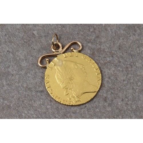 1090 - A George III gold guinea, mounted as a pendant, 1787, fifth laureate head right, spade shaped shield... 