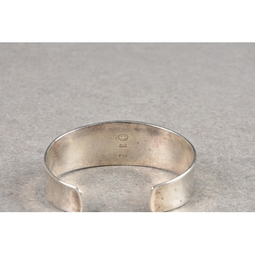 1124 - A Georg Jensen silver bangle, the torc bangle of slightly concave form, stamped '188' and with maker... 