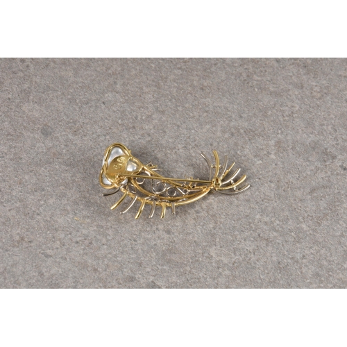 1130 - An 18ct two colour gold and baroque pearl fish brooch, stamped with maker's mark and '750', the baro... 