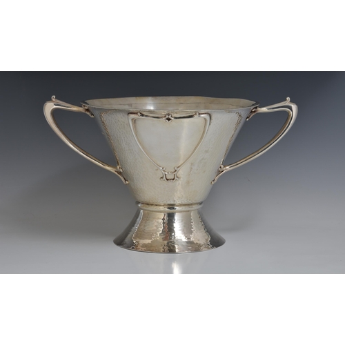 125 - A rare Art Nouveau planished silver centrepiece / twin handle trophy bowl, Goldsmiths & Silversmiths... 