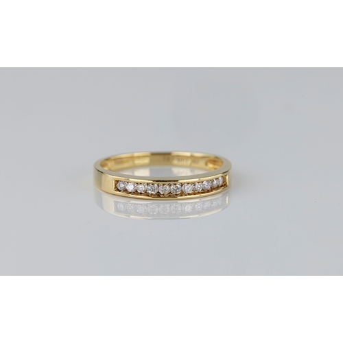 1366 - An 18ct gold and diamond half eternity ring, '750' and London hallmarks, with eleven, channel set br... 