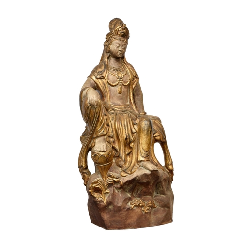 1490 - An Oriental parcel gilt stoneware figure of Buddha, 20th century, dressed in gilt robed, seated upon... 